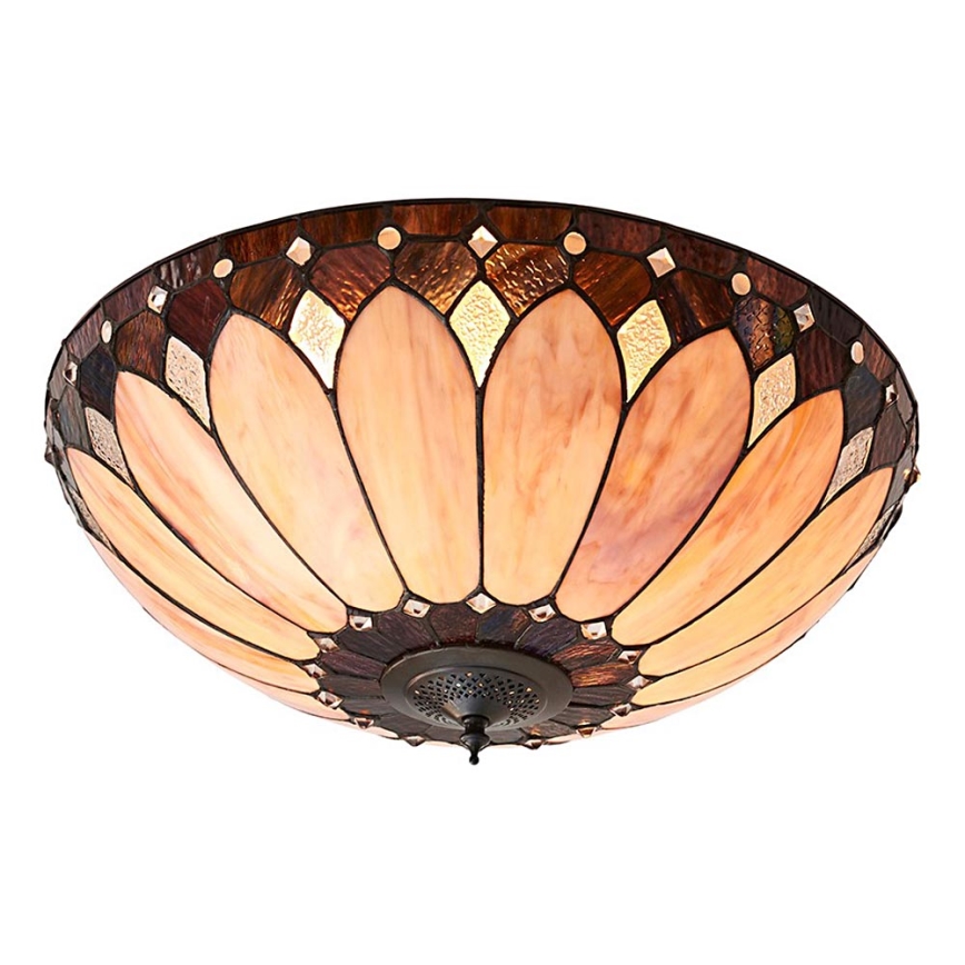 Svietidlo s tienidlom z farebného skla s okvetným tvarom osvetľuje priestor. Tienidlo má hnedo-oranžové odtiene a kovový základ. Je umiestnené na bielom pozadí.