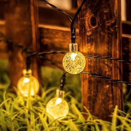 LED solárna dekoračná svetelná reťaz 50× LED / 8 režimov, 500 mAh, 9,5 m, IP67, teplá biela